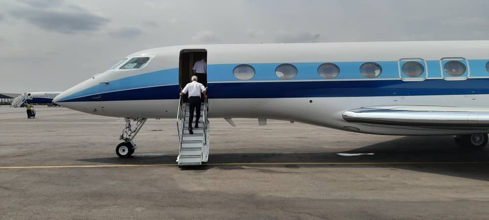 Passenger boarding blue-striped Gulfstream