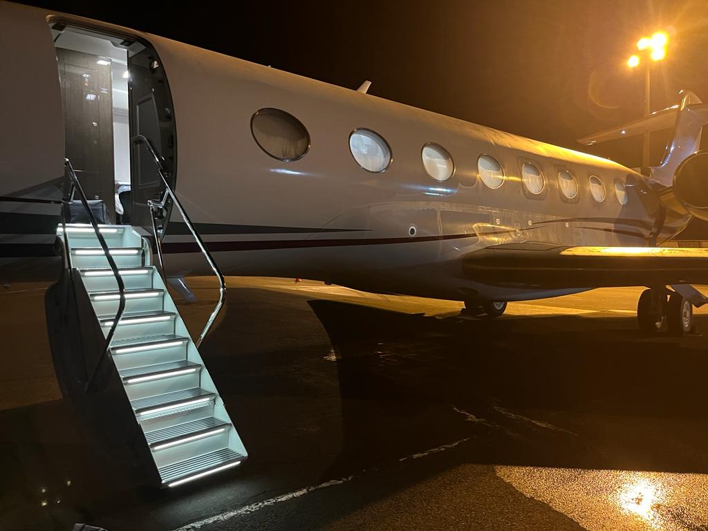 Gulfstream with illuminated stairs at night