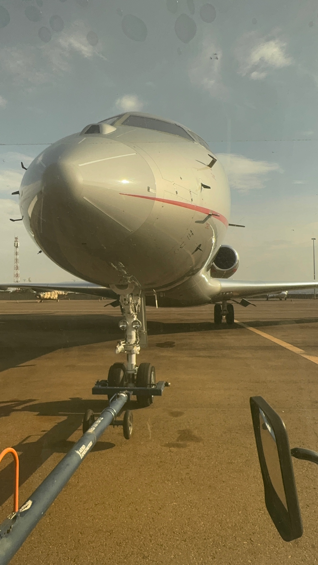 Private jet nose view during tow bar pushback on ramp